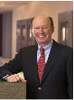 A headshot of board member John F. Brock.